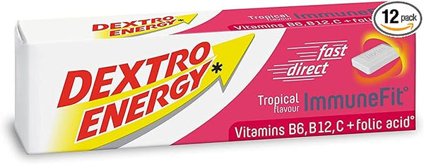 The Dextro Energy Tropical Tablets (47g) box displays a yellow arrow and bold red Tropical flavour ImmuneFit text, featuring vitamins B6, B12, C + folic acid. It includes a fast direct symbol and notes a 12-pack in the top right.