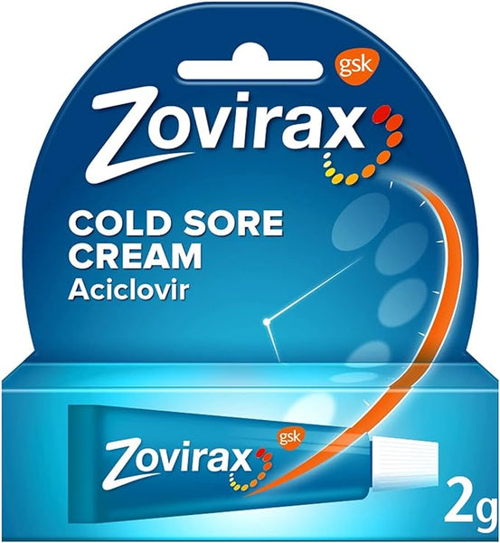 Zovirax Cold Sore Cream 2g packaging showcases anti-viral Aciclovir in a blue box with the logo and an orange arc representing application. A small GSK logo appears in the corner.