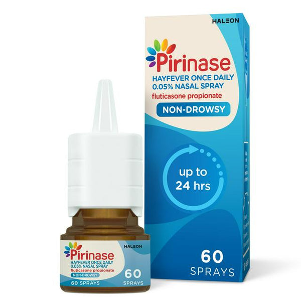 A Pirinase Once Daily For Adults nasal spray (60 sprays) with 0.05% fluticasone propionate and a white cap is beside its blue and white box, labeled non-drowsy, up to 24 hrs, for effective hayfever symptom relief.