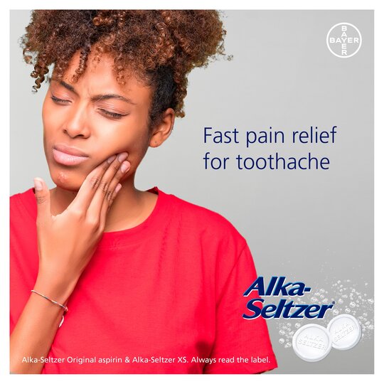 A person in a red shirt touches their cheek, appearing to have a toothache. The text reads Fast pain relief for toothache accompanied by the Alka-Seltzer XS logo and two effervescent tablets. Featuring Alka-Seltzer XS Double Action Pain Relief Tablets (20 Tablets).