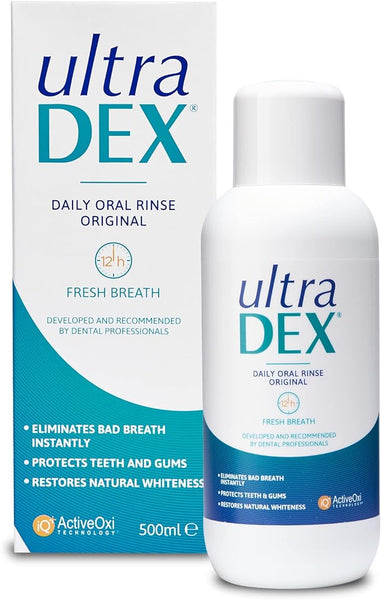 A 500ml bottle and box of Ultradex Daily Oral Rinse With Fluoride, by Ultra Chloraseptic, in Original flavor for fresh breath. Ideal with your sore throat spray, it eliminates bad breath, protects teeth and gums, and restores natural whiteness.