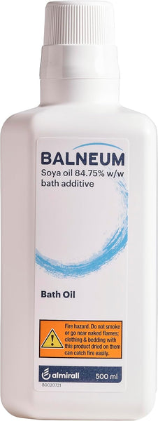 The 500ml Almirall Balneum Bath Oil, ideal for dry and sensitive skin, is a white bottle containing 84.75% soya oil. It includes a flammability warning and advises precautions around fire and smoking.