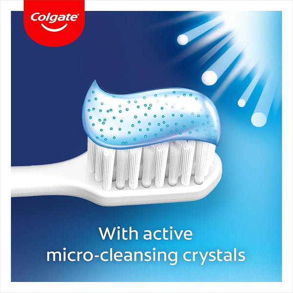 A white toothbrush topped with blue Colgate Advanced White Toothpaste (50ml) featuring micro-cleansing crystals, illuminated by light beams. Text: With whitening micro-cleansing crystals. Colgate logo in corner.