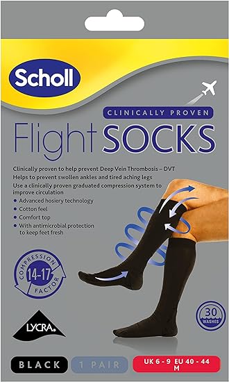 The Scholl Flight Socks Black packaging depicts someone in knee-high compression socks, showcasing benefits like deep vein thrombosis prevention, reduced swelling, antimicrobial protection, comfort top, and a compression factor of 14-17mmHg; available in size 6-9.