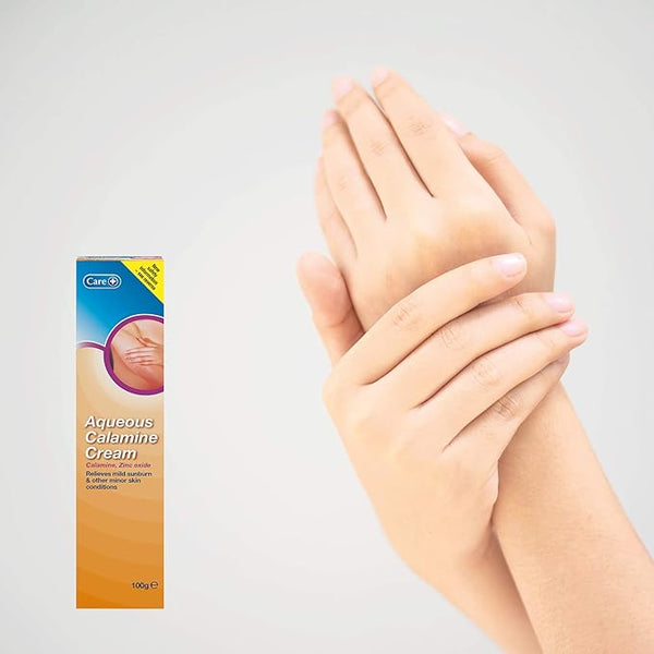 A box of Care Aqueous Calamine Cream (100g) appears on the left. On the right, hands gently hold each other against a light background, implying the use of this cream by Care for soothing sunburn relief and easing skin irritation.