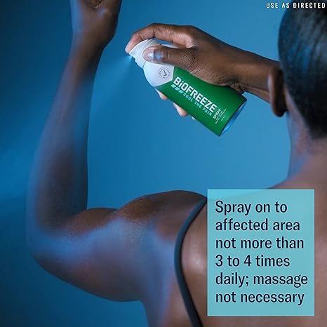 Applying Biofreeze Pain Relieving Spray (118ml) to shoulder for pain relief. Instructions: Spray on affected area up to 4 times daily; massage not needed. Blue background with USE AS DIRECTED in top right, highlighting effective cryotherapy. Brand: Biofreeze.