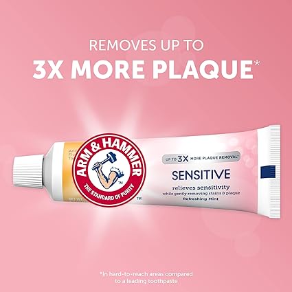 Against a pink background is an Arm and Hammer Sensitive Toothpaste (125g) tube. The text highlights Removes up to 3X more plaque* and mentions it Relieves sensitivity while gently removing stains & plaque. Enjoy cavity protection with the power of baking soda in Refreshing Mint flavor.