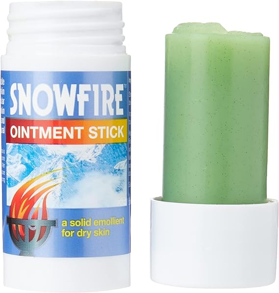 The Snowfire Ointment Stick (18g) by Snowfire, in a white tube adorned with snowy mountains and a flame symbol, is perfect for chapped hands and dry skin. Made from natural ingredients, its cap rests neatly beside the stick.