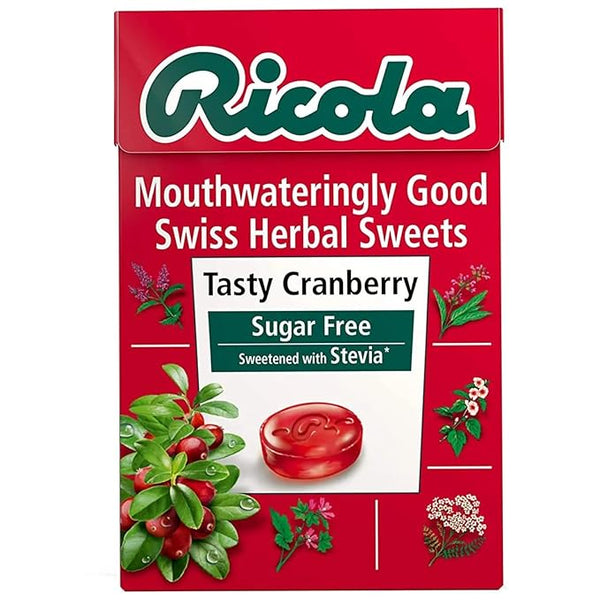 The red Ricola Swiss Herb Drops Sugar-Free Cranberry Box (45g) features the text Mouthwateringly Good and Sweetened with Stevia, with images of cranberries, herbs, and the signature 13-herb mixture adorning the packaging.