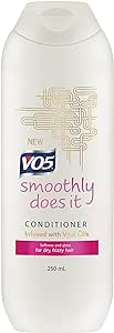 The VO5 Smoothly Does It Conditioner (250ml) features a sleek white bottle with golden abstract lines and a fresh formula infused with 5 vital oils. Perfect for dry, frizzy hair, it delivers a rejuvenating touch.