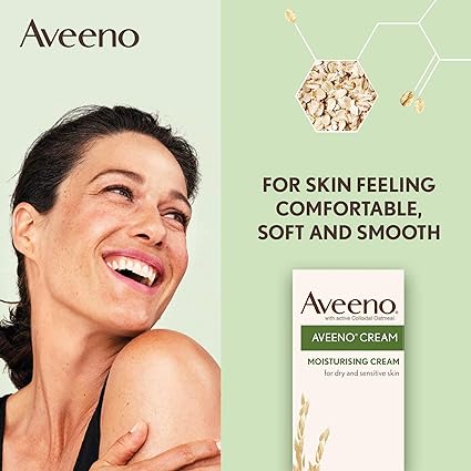 A smiling woman leans against a light green backdrop. Text reads, Aveeno Cream (300ml): Moisturizing for Dry and Sensitive Skin by Aveeno. The image showcases colloidal oatmeal, emphasizing its natural ingredients.