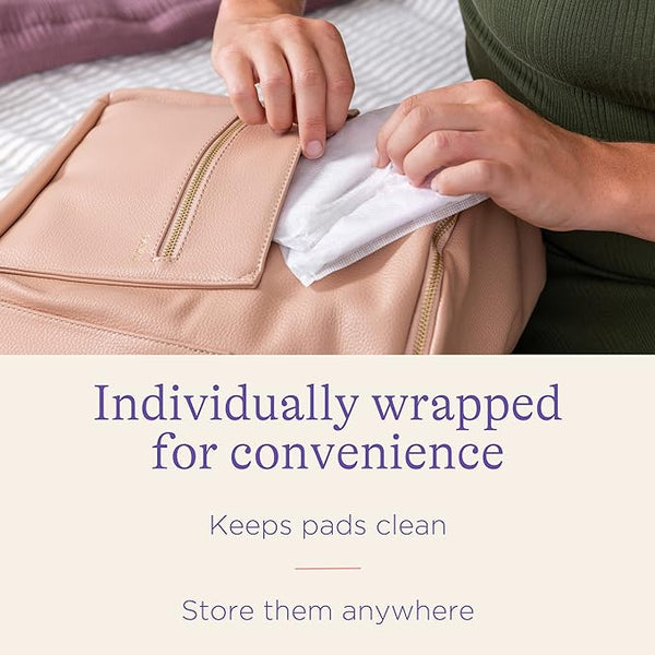 A person places an individually wrapped Care Lansinoh Disposable Breast Pad with an ultra-absorbent core into a beige bag. Text on the image reads: Individually wrapped for convenience. Keeps pads clean. Store them anywhere.