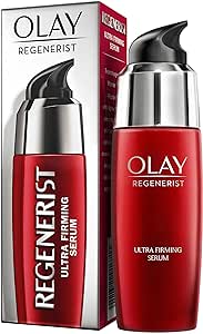 The red Olay Regenerist 3 Point Super Serum (50ml) from Oilatum, featuring a black pump and white product details, comes with a matching box. It nourishes and rejuvenates the skin, providing moisture for dry conditions.