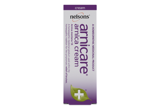 The image shows a box of Nelsons Arnicare Arnica Cream (30g), a homeopathic remedy for bruises and aching muscles. The predominantly purple and white box features a green leaf and white cross icon, suitable for sensitive skin.