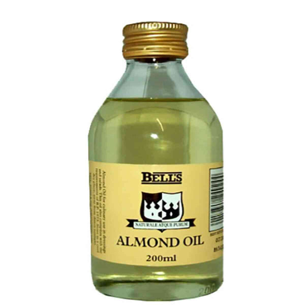 A clear bottle with a gold screw cap houses Bells Almond Oil, known for its emollient properties. The beige label indicates its a 200ml bottle, ideal for enhancing skin complexion.