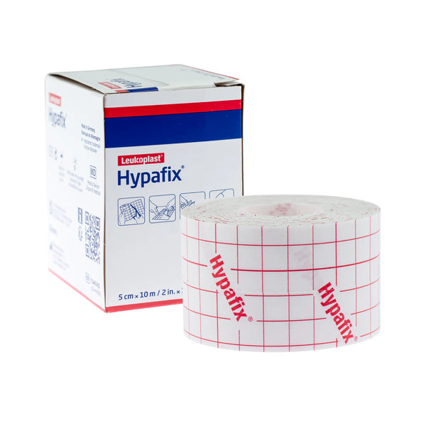 A roll of Hypafix Hypoallergenic Dressing Tape 5cm x 10m sits next to its branded box, featuring a red grid pattern and logo. This non-woven, self-adhesive tape is ideal for secure and gentle dressing fixation.