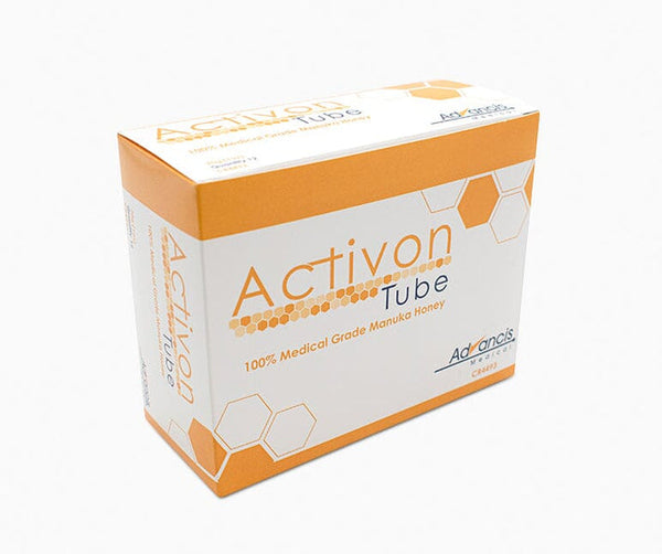 The Advancis Activon Manuka Honey Tube (25g) features 100% medical-grade Manuka honey for natural healing, with an orange and white design accented by honeycomb patterns.