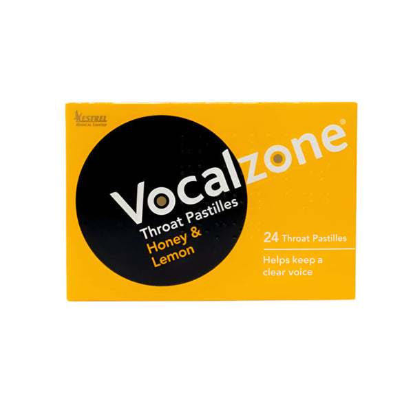 The Vocalzone Honey and Lemon (24 Pastilles) box features a yellow design with a large black circle and Honey & Lemon text. It promises throat irritation relief, with white lettering stating, Helps keep a clear voice.