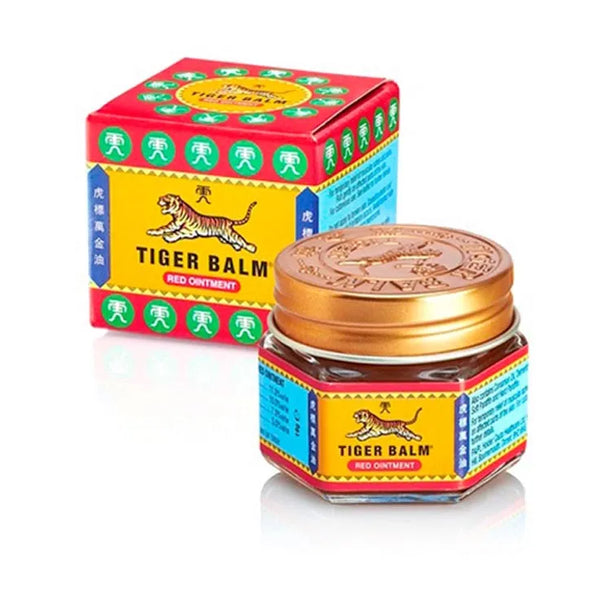 The 19g Tiger Balm Red Ointment, known for its herbal formula, is in a small glass jar with a gold lid. Its colorful packaging features a tiger illustration and Chinese characters on a vibrant yellow and red background, ideal for muscle relief.