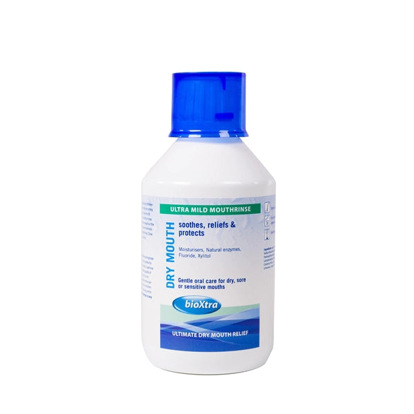 A white bottle of BioXtra Moisturising Anti-Plaque Mouthrinse (250ml) with a blue cap. The label highlights soothing, relieving, and protecting dry or sensitive mouths while addressing oral dryness. It contains moisturizers, natural enzymes, fluoride, and xylitol for effective care.