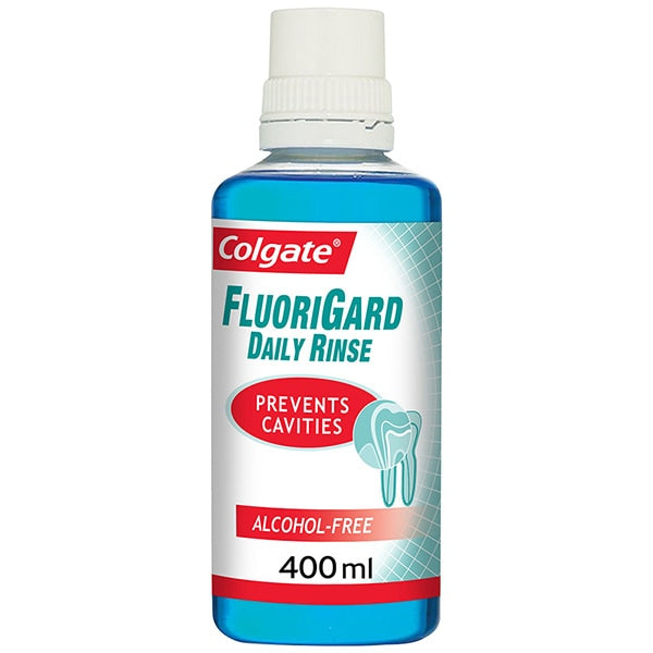 A bottle of Colgate Blue Mint Fluorigard Daily Rinse, 400ml, is displayed with a white cap and a label stating Prevents Cavities and Alcohol-Free. It features an enamel-friendly, fluoride-based formula with a refreshing blue rinse inside.