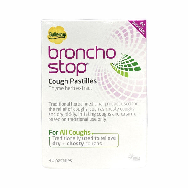 A prominently displayed box of Buttercups Bronchostop Cough Pastilles, featuring thyme herb and marshmallow root extracts, is mostly white with purple and green text. This 40-pack traditionally soothes dry and chesty coughs.