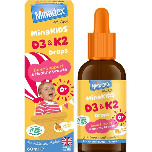 Minakids D3 and K2 Drops (60ml) for babies and children come in a bottle with dropper, orange flavor, and support bone health and healthy growth. The colorful Minakids box features a smiling baby on the front.