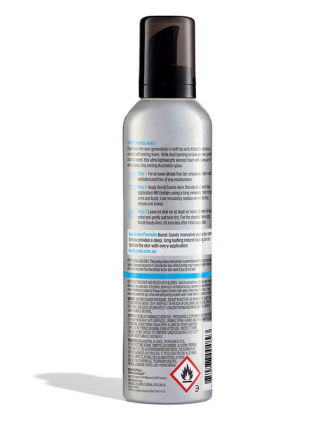 The Bondi Sands Aero Aerated Self Tanning Foam Coconut Scent (225ml) comes in a silver aerosol bottle with a black cap and back label instructions, offering a streak-free tan. A flammable warning symbol appears near the bottom.